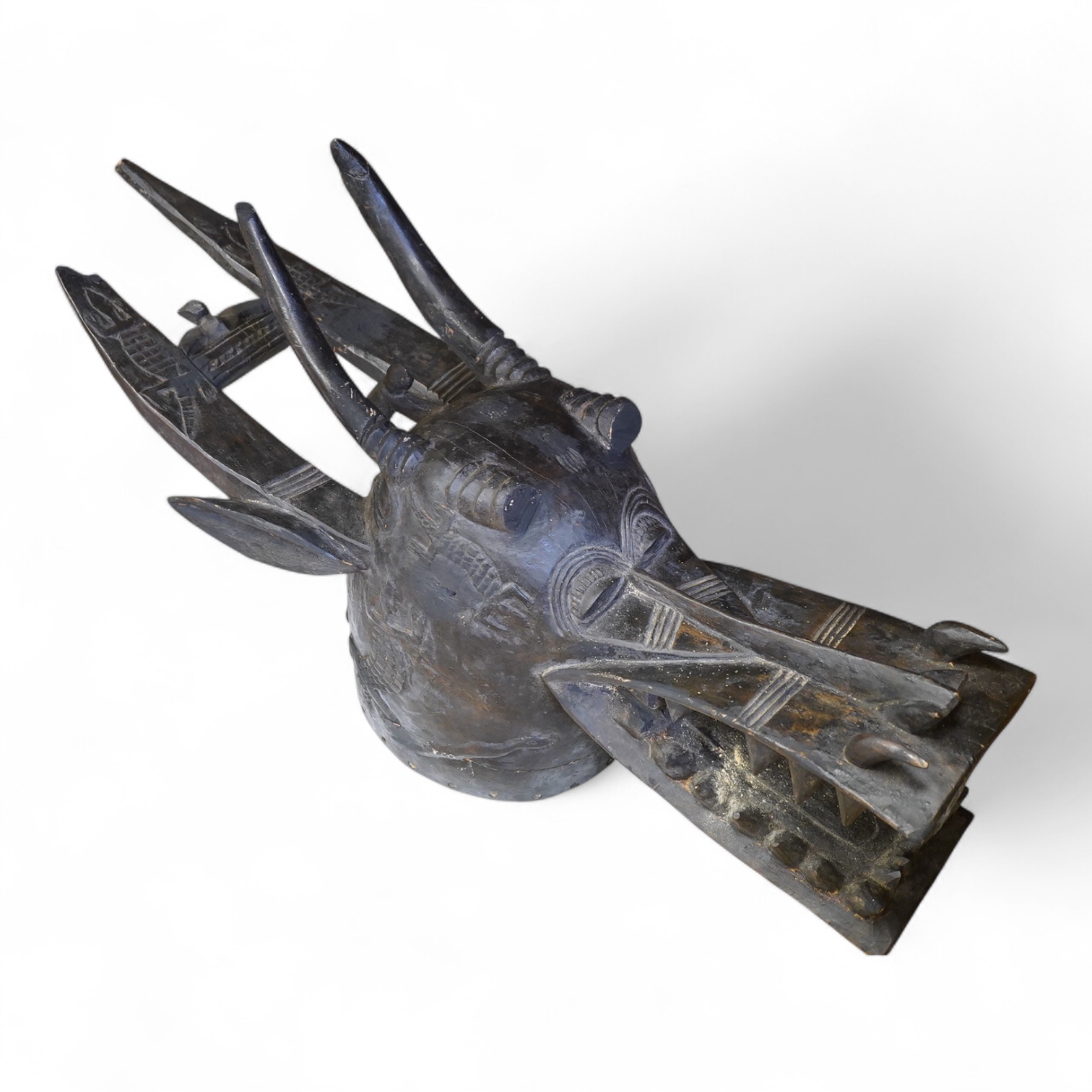 African art - a Senufo carved wooden helmet mask (Kponyugo), Ivory Coast, early 20th century, 88cm